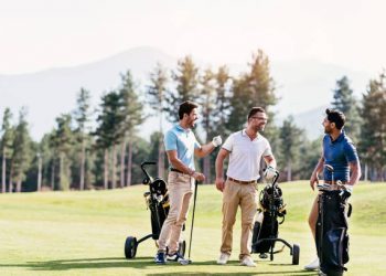 Multi-ethnic group of young men walking on a golf course
