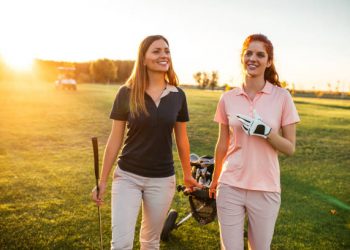 Two women walking on the golf coarse